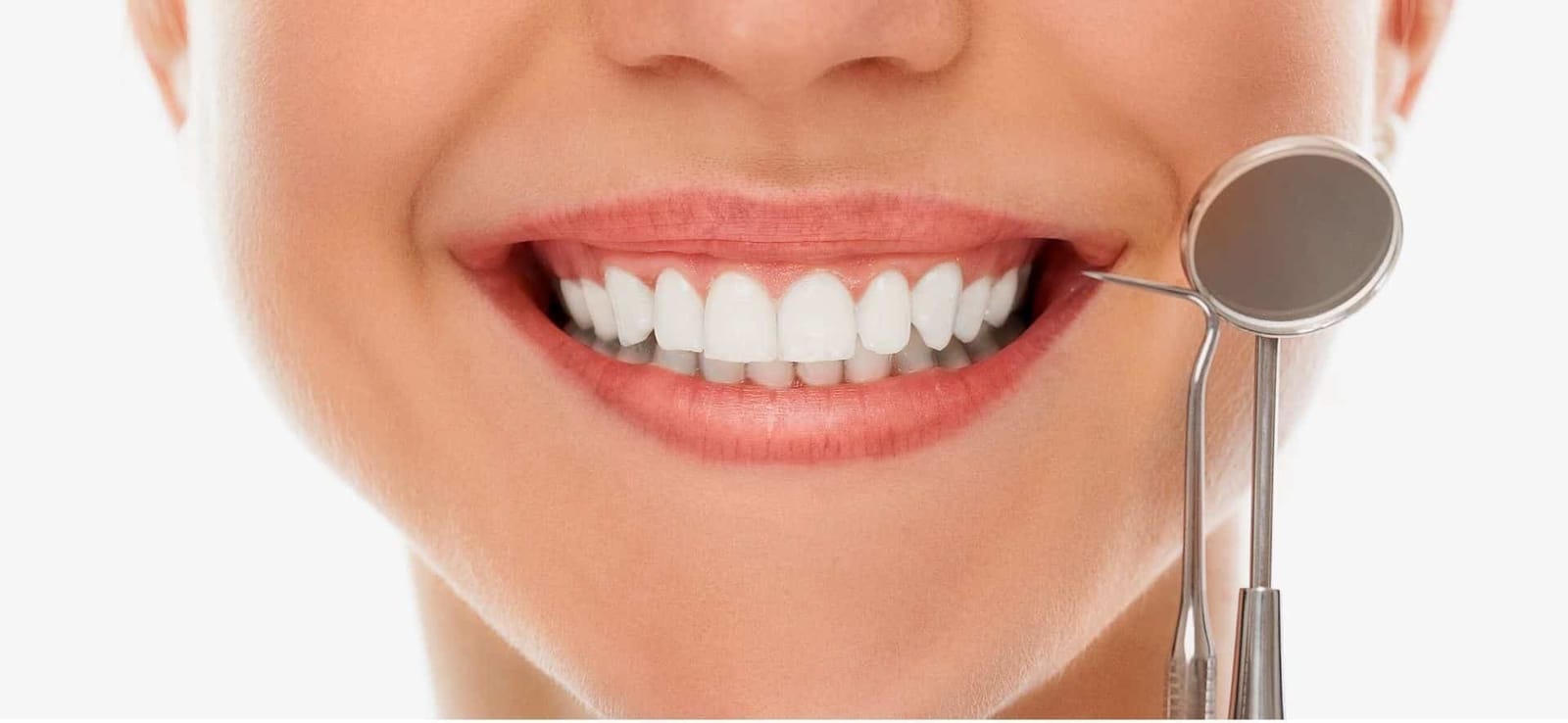A smiling mouth beside a dental mirror