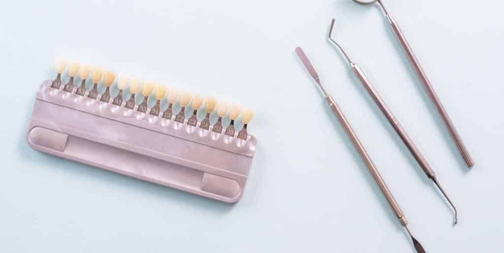 Tooth shade samples beside dental instruments
