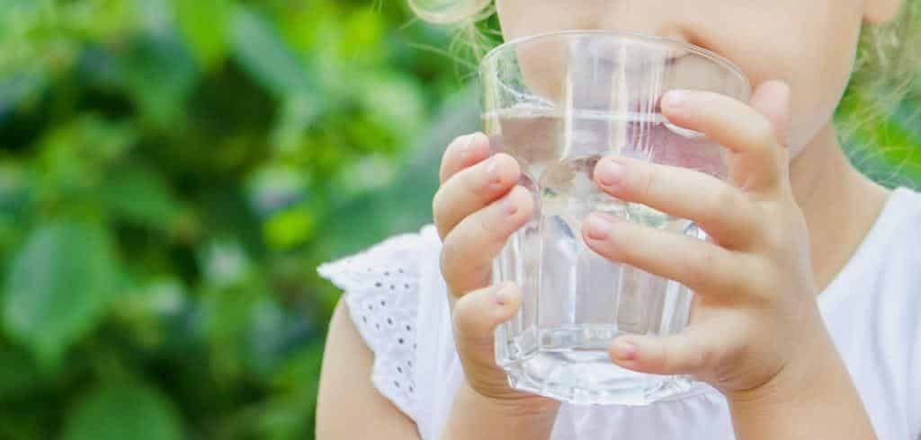 A child holding a glass of water