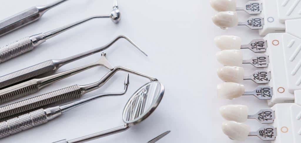 Dental instruments beside a tooth shade guide