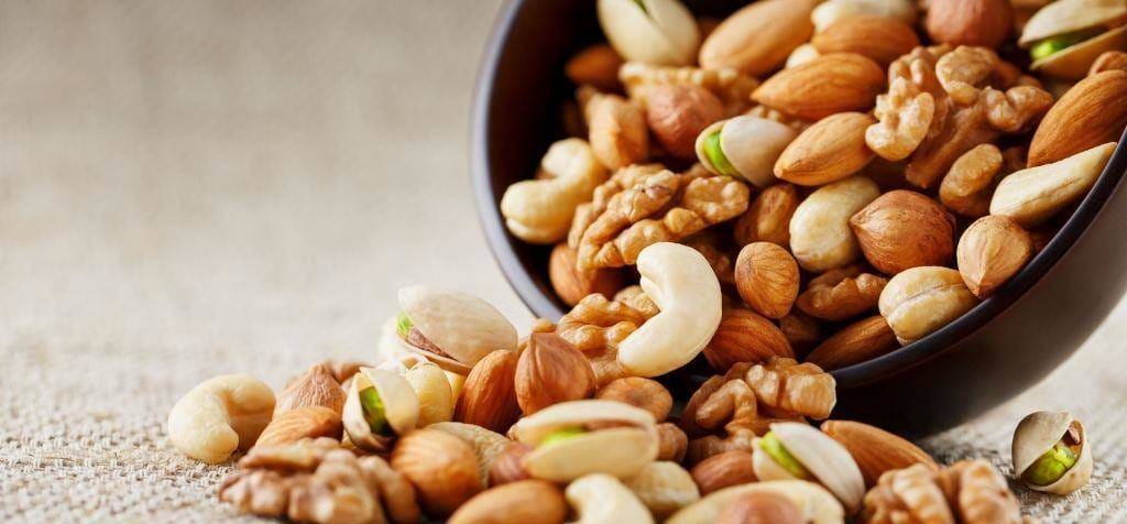 A bowl of mixed nuts, including walnuts, almonds and pistachios