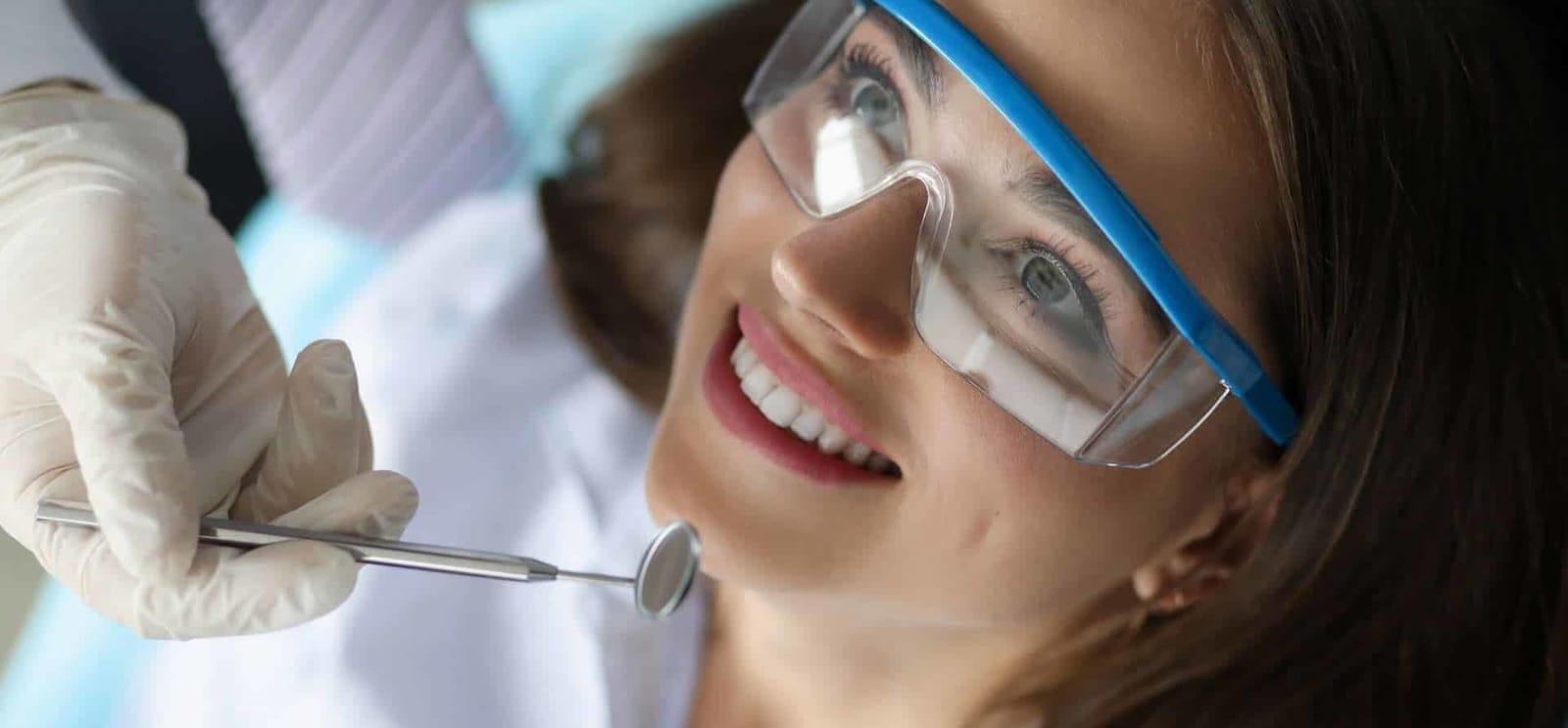 Patient wearing protective glasses during a dental examination