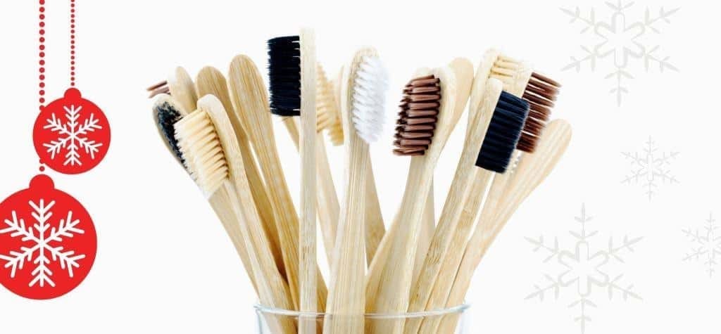 Wooden-handled toothbrushes beside Christmas decorations