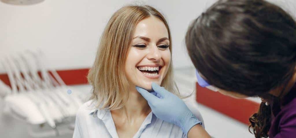 A patient smiling during a dental examination