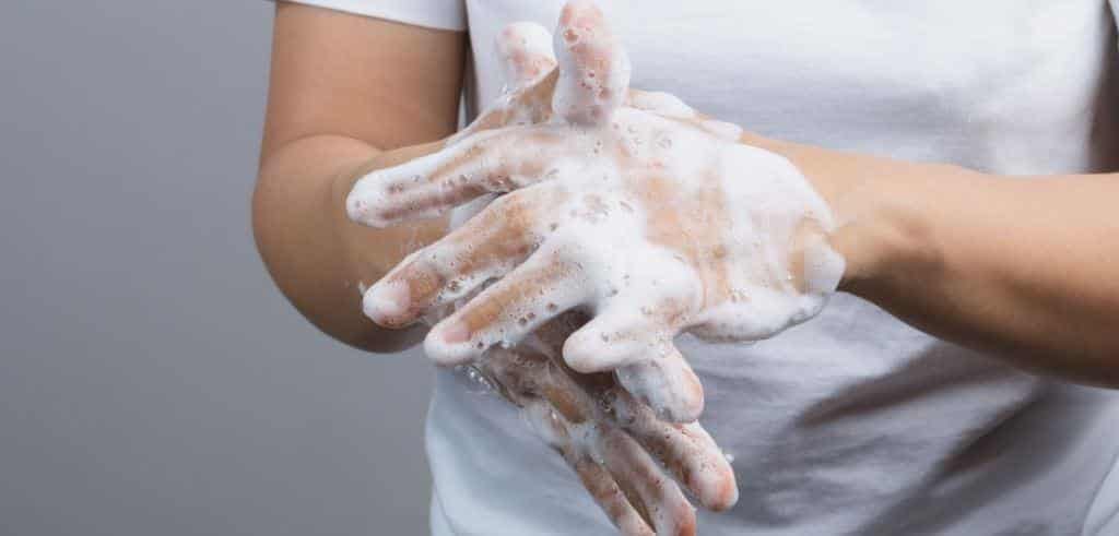 Hands being washed with soap under running water