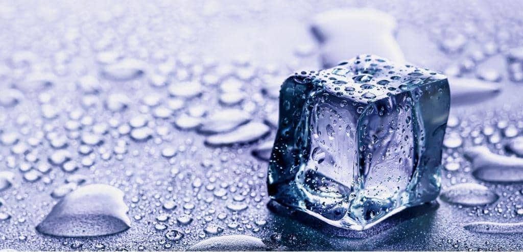 An ice cube on a dark background