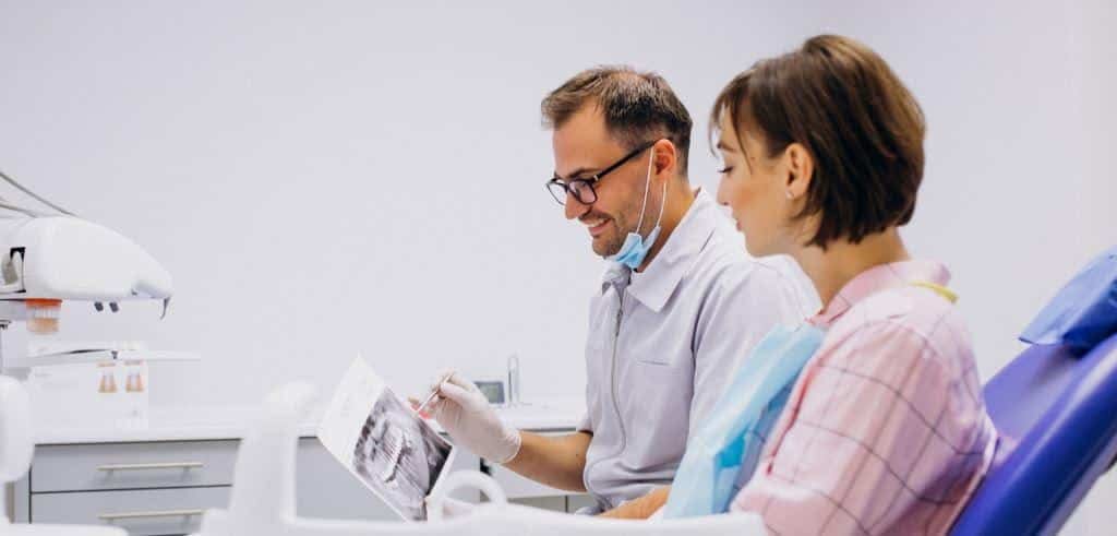 Dental professional discussing an X-ray with a patient