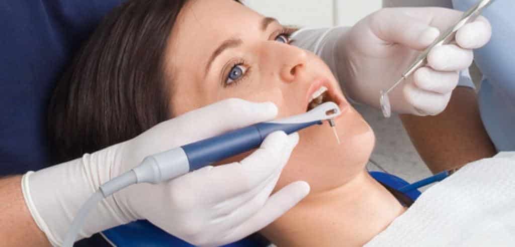 Dental treatment using a handpiece