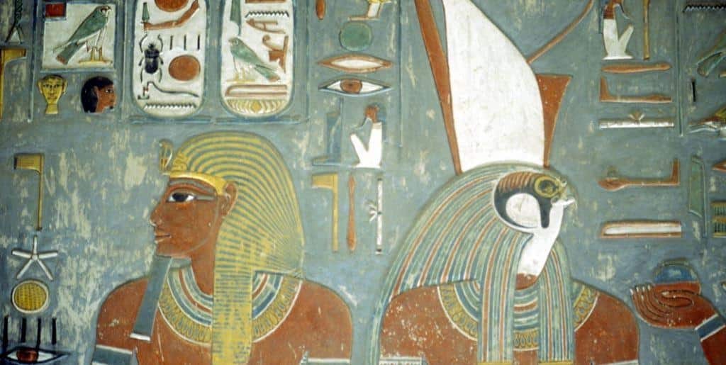 Painted Egyptian figures and hieroglyphs on a wall