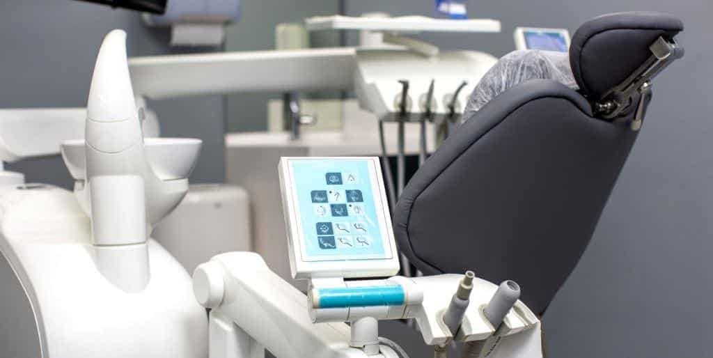 A modern dental chair and equipment in a surgery