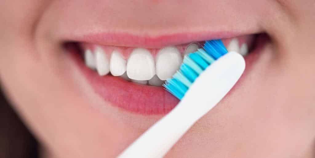 A person brushing their front teeth