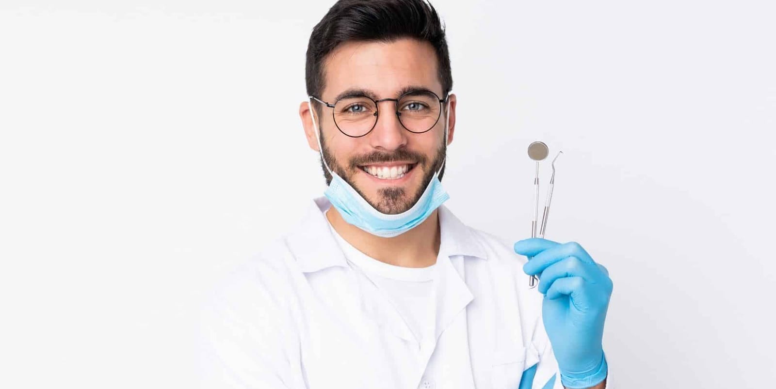 A clinician holding a dental mirror and instrument