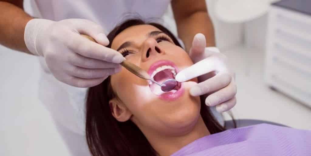 A patient having a dental examination with a mirror