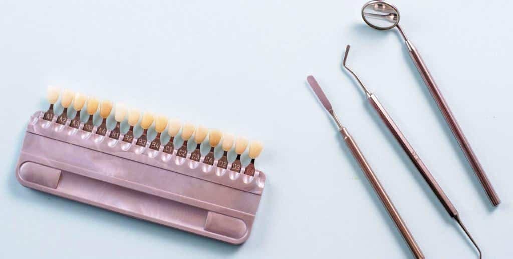 A tooth shade guide and dental instruments