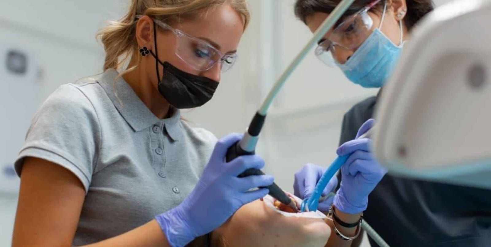 Two clinicians working together during dental treatment