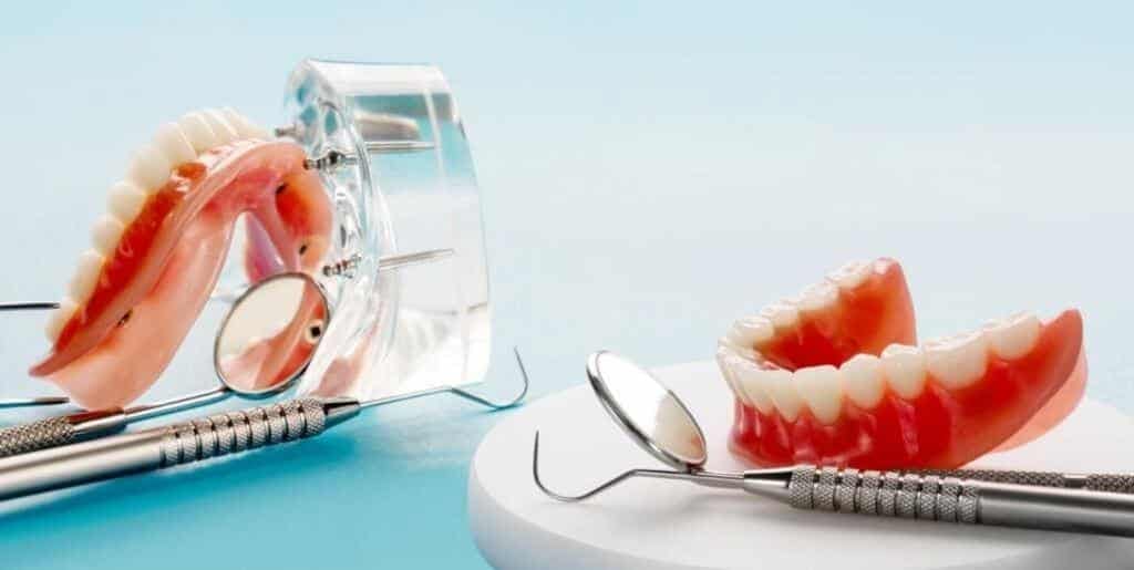 Dentures and dental mirrors on a work surface