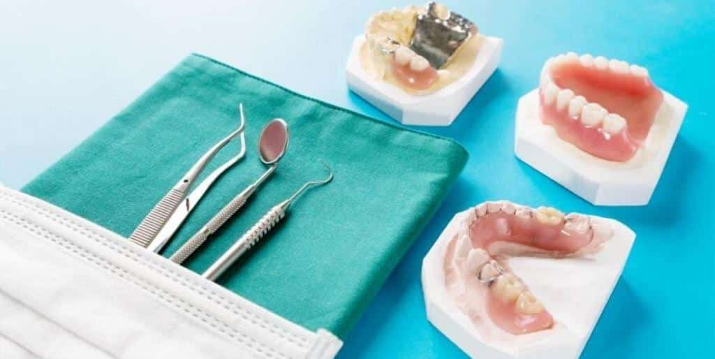 Denture models beside dental instruments