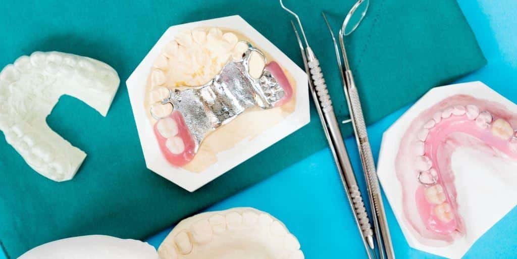 Denture models and dental instruments arranged on a cloth