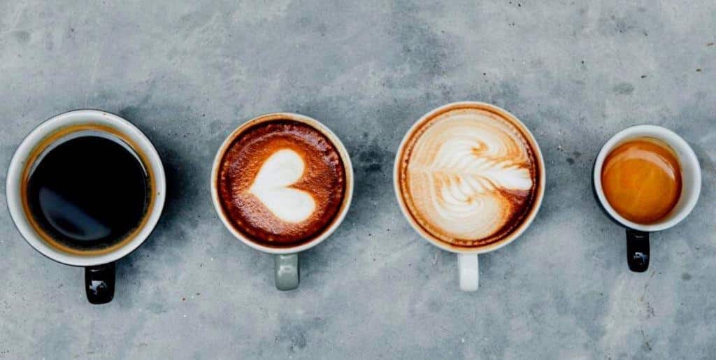 Four cups containing different coffee drinks