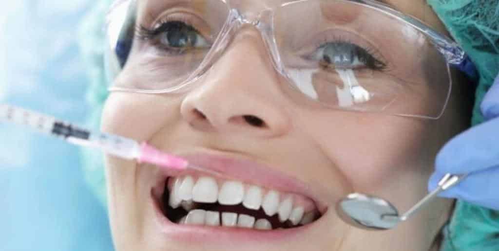 Patient wearing protective glasses during dental care