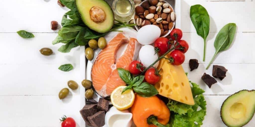 Fish, vegetables, fruit, nuts and other foods on a table