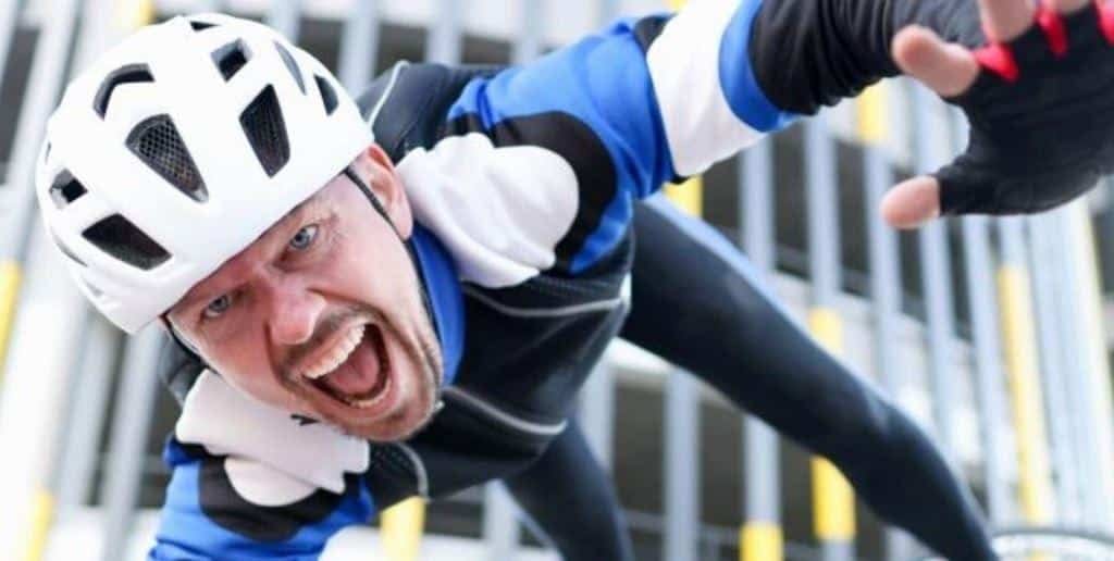 A cyclist wearing a helmet during a fall