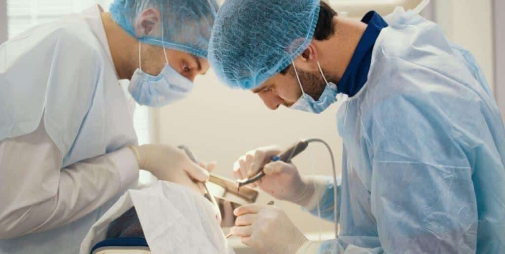 Clinicians carrying out a procedure in a patient’s mouth