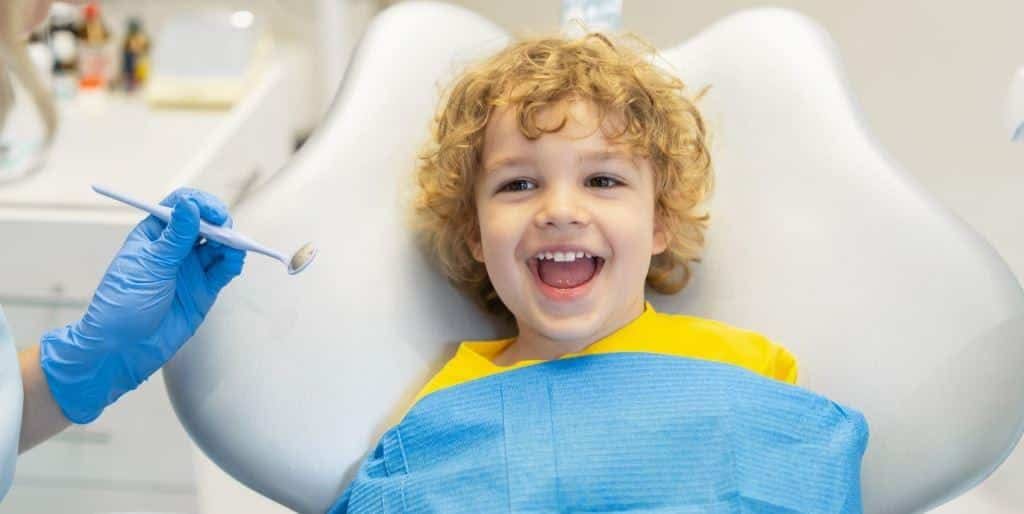 A child smiling during a dental examination