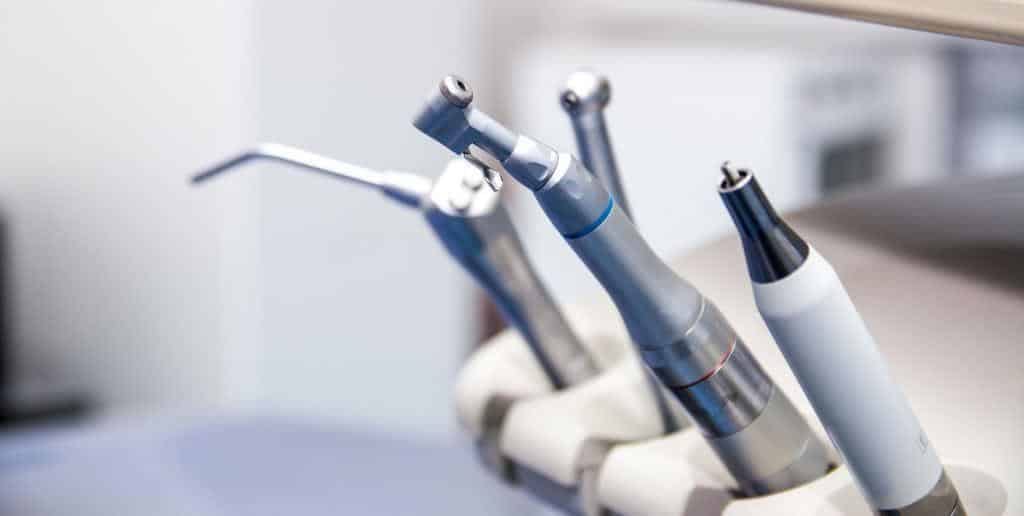 Dental handpieces beside a treatment chair