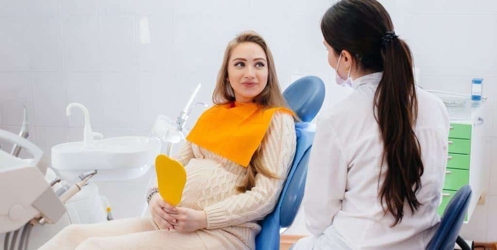 Patient talking with a dentist in a surgery