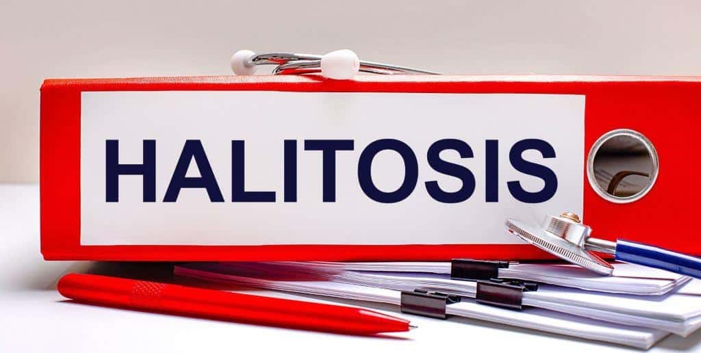 Folder labelled Halitosis beside dental instruments