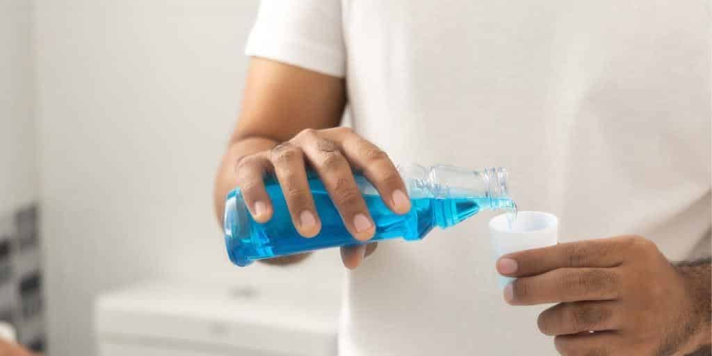 Mouthwash being poured into a cup