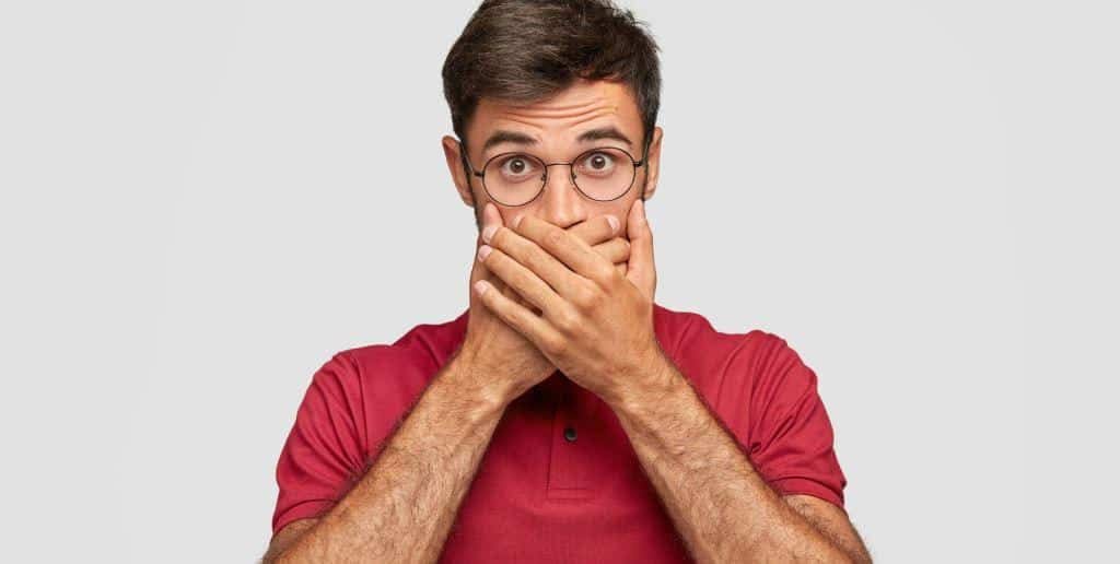 Man covering his mouth with his hands