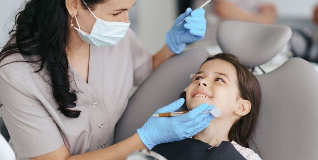 Dentist examining a child’s teeth