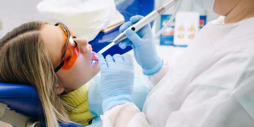 A patient wearing protective glasses during a dental procedure