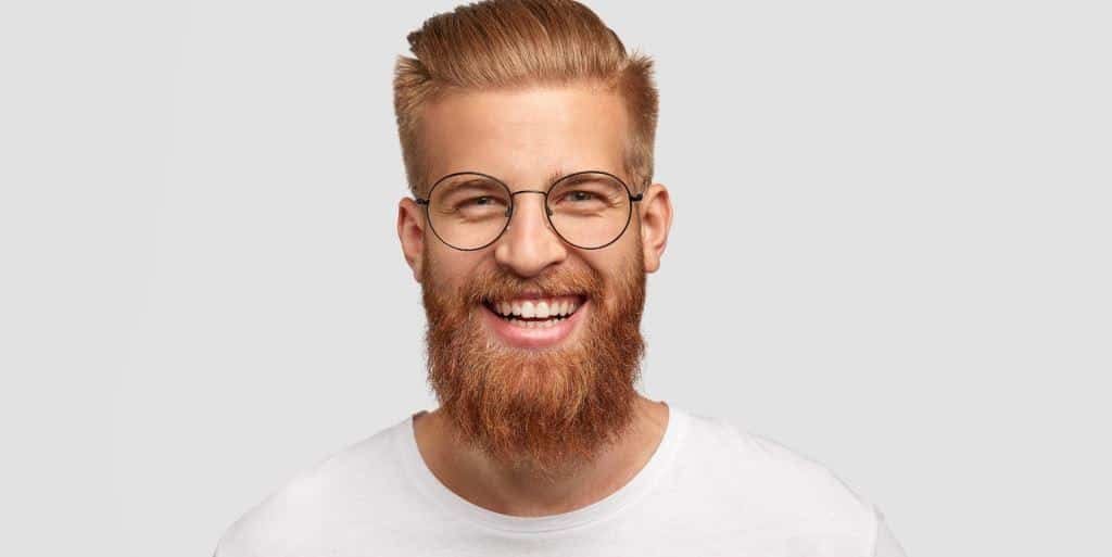 A smiling man wearing glasses