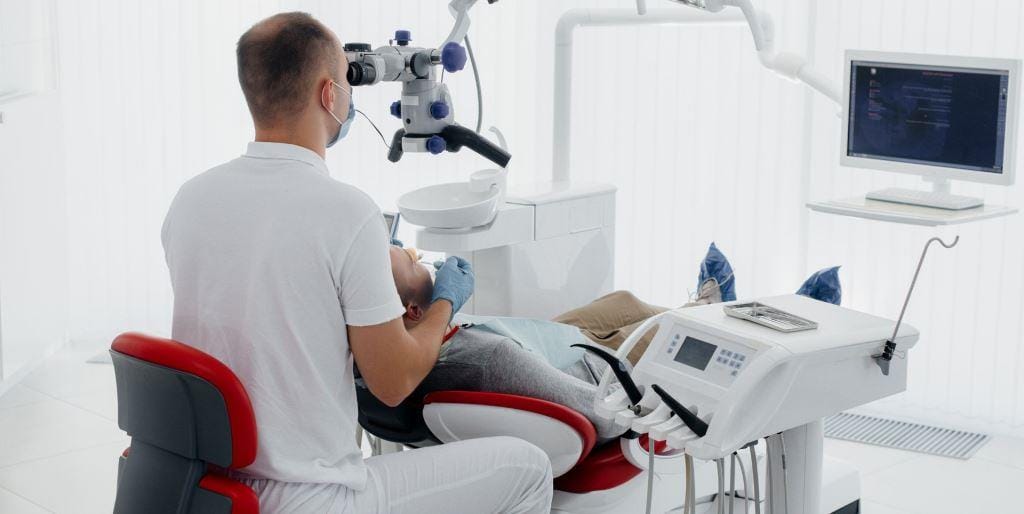Dentist using a microscope during treatment