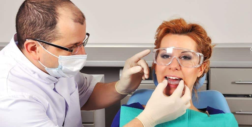 A clinician carrying out a dental examination