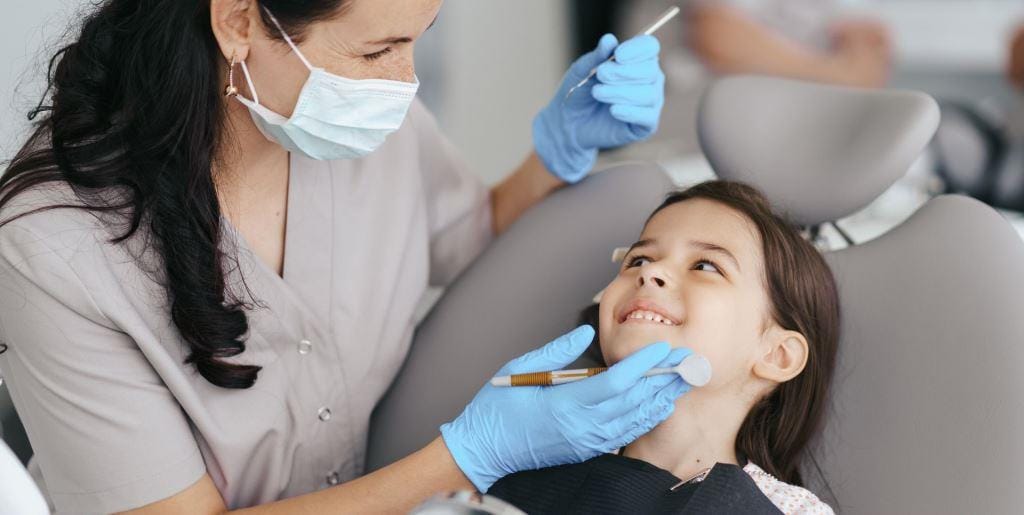 Dentist examining a child’s teeth