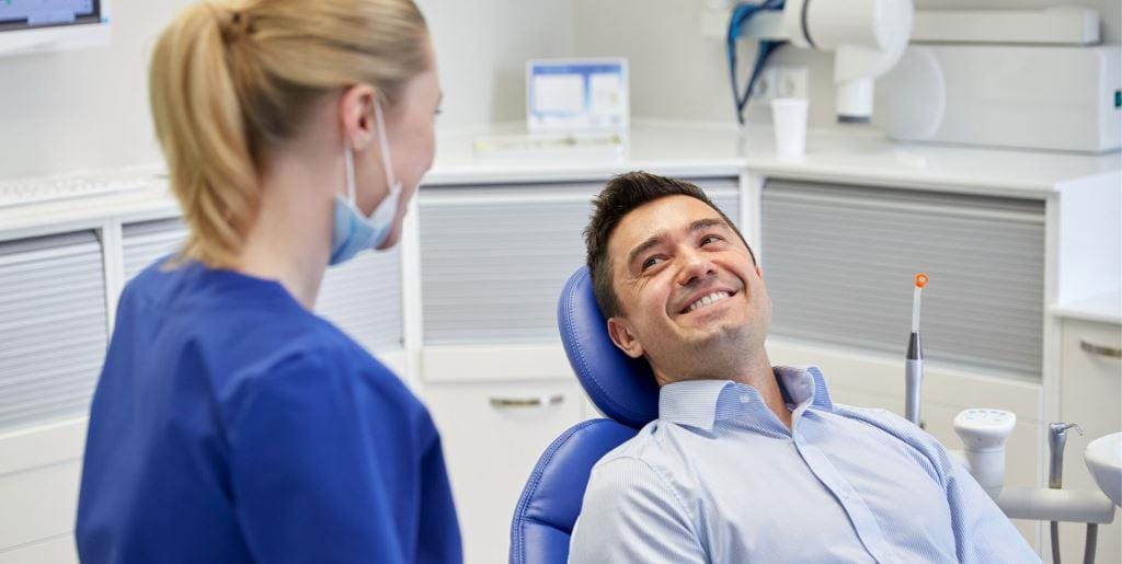A patient talking with a member of the dental team