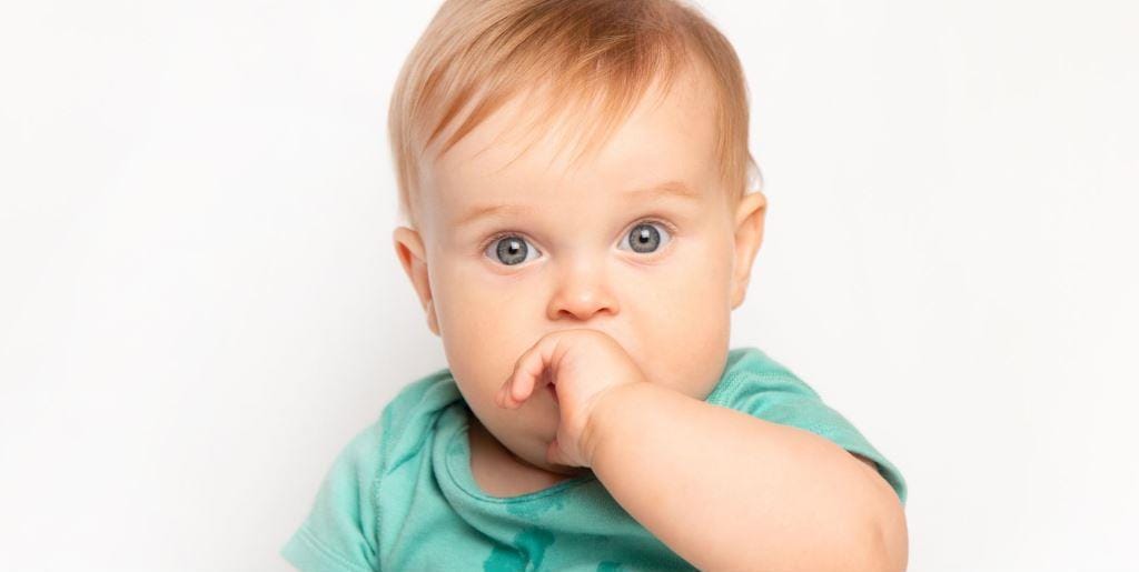 Baby with a finger in their mouth
