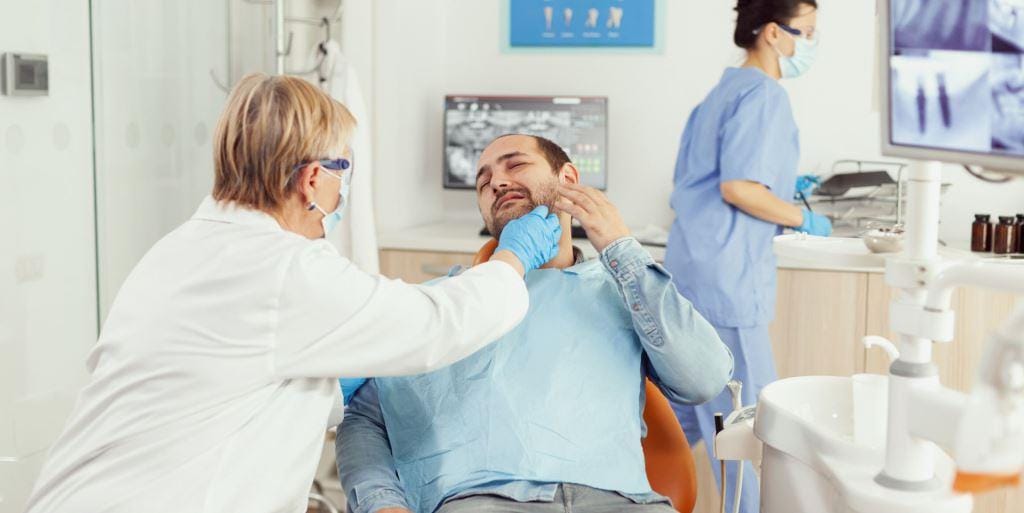 Dentist examining a patient’s jaw during an appointment