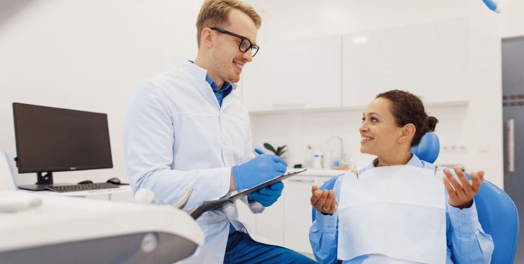 Dentist discussing a patient’s concerns during a consultation