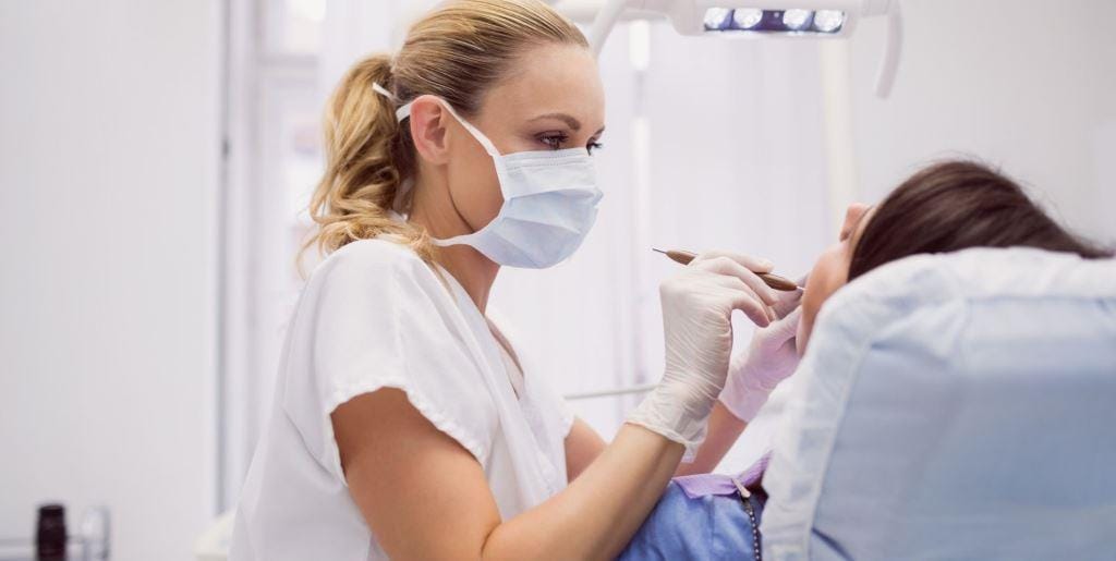 A dentist examining a patient