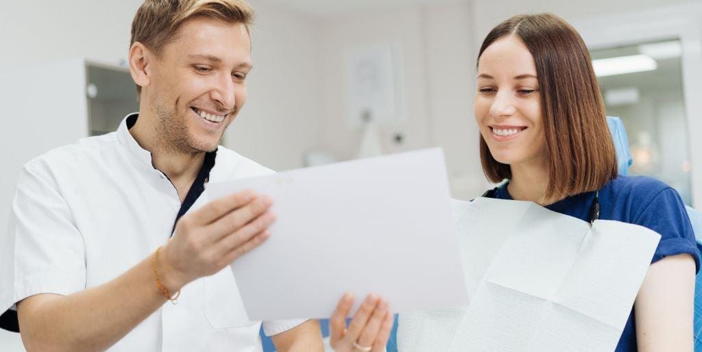 Dentist and patient looking at documents together