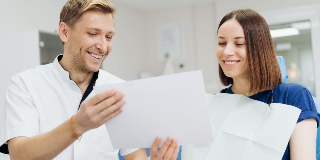 Dentist discussing paperwork with a patient