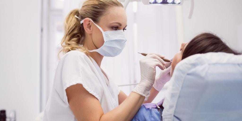 Dentist examining a patient’s mouth