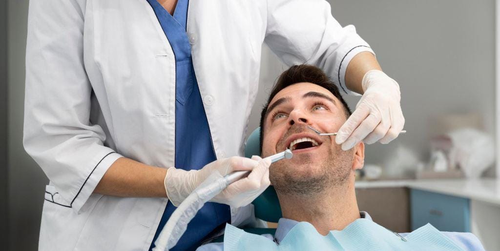 A dentist examining a patient’s mouth