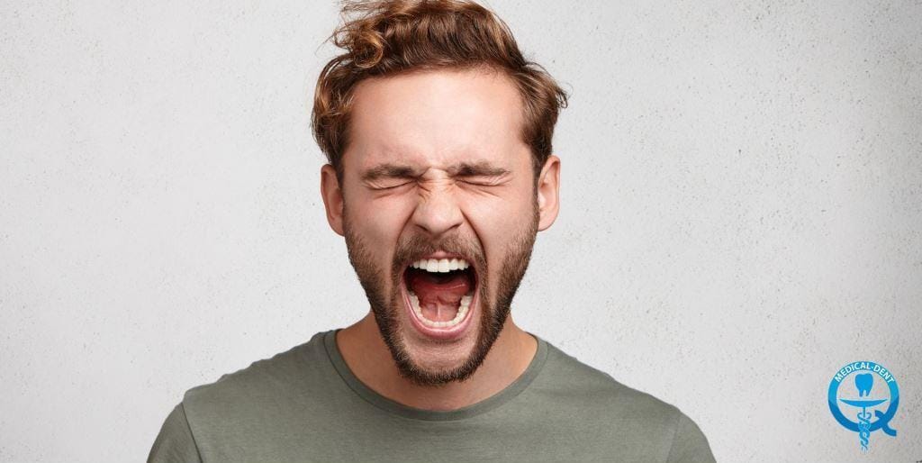 A man with his eyes closed and mouth open