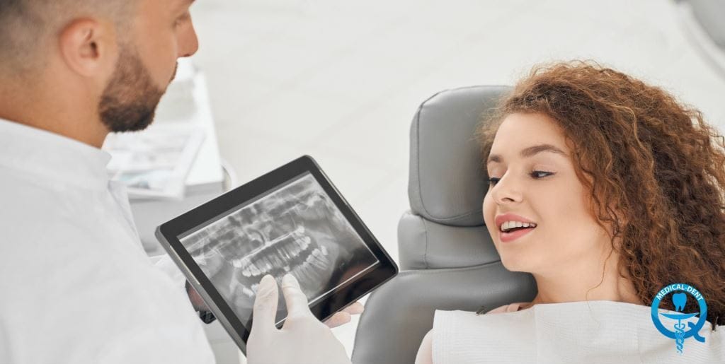 Clinician discussing an X-ray on a tablet with a patient